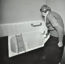 16 Candy Street, Poplar, London: elderly woman in bathroom, 1962. Creator: Unknown