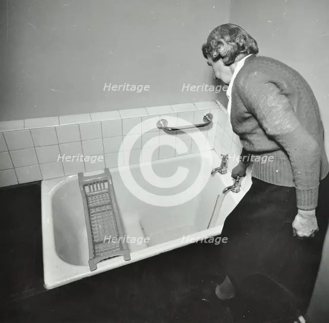16 Candy Street, Poplar, London: elderly woman in bathroom, 1962. Creator: Unknown.