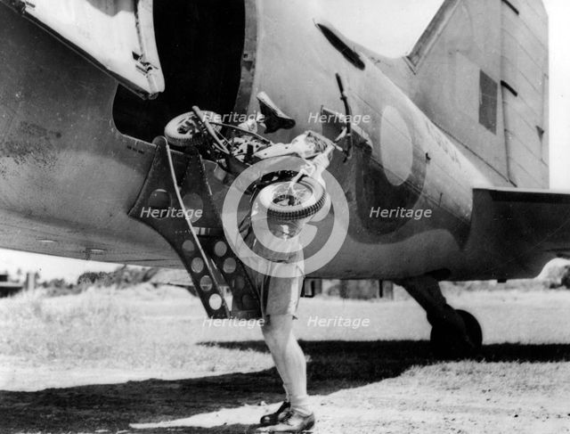 1944 Welbike being placed on to military transport plane. Creator: Unknown.