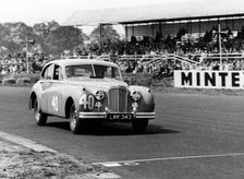 1953 Jaguar MkVII, Stirling Moss at Silverstone. Creator: Unknown