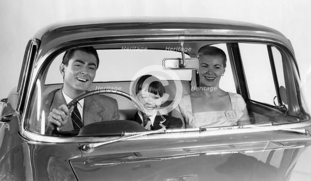 1957 Vauxhall Victor with family together in front seat. Creator: Unknown.