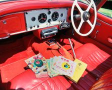 1960 Jaguar XK150 interior with record player and 7inch vinyl discs.. Creator: Unknown