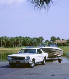 1967 Ford Mustang towing a boat