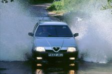 1989 Alfa Romeo 164 driving through a ford