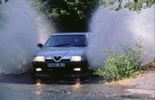 1989 Alfa Romeo 164 driving through a ford