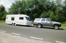 1995 Toyota Landcruiser towing large caravan at speed