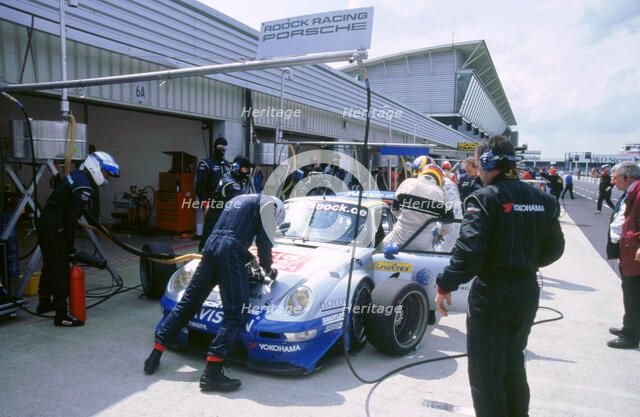 1999 Porsche 911 GT2 in pits.FIA GT Silverstone 500. Artist: Unknown.