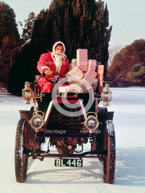 1901 Durkopp with Santa Claus delivering Christmas gifts. Creator: Unknown.