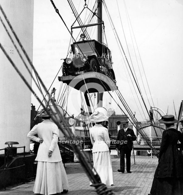1910 Mercedes being craned onboard ship. Creator: Unknown.
