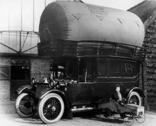 1913 Lanchester with gas bag conversion and boy in pedal car. Creator: Unknown