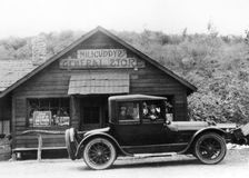 1916 Cadillac V8 car, parked outside a general store, USA, (c1916?)