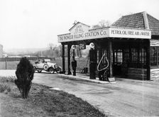 1923 10 hp Calcott arriving at a petrol station, (c1923?)