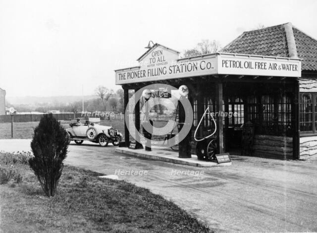1923 10 hp Calcott arriving at a petrol station, (c1923?). Artist: Unknown