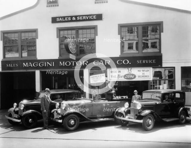 1932 Ford V8 in front of a car showroom, (c1932?). Artist: Unknown