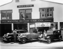 1932 Ford V8 in front of a car showroom, (c1932?)