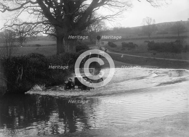 1932 Morris Minor tourer driving through a ford during a motoring trial, 1936. Artist: Bill Brunell.