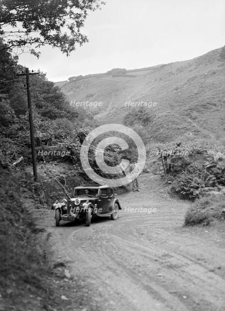 1934 Riley Falcon saloon taking part in a motoring trial in Devon, late 1930s. Artist: Bill Brunell.