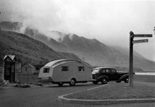 1936 Oldsmobile Eight with caravan in Scotland. Creator: Unknown