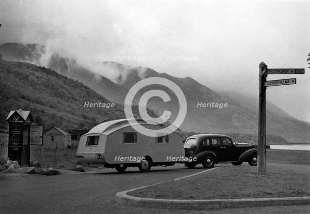 1936 Oldsmobile Eight with caravan in Scotland. Creator: Unknown.
