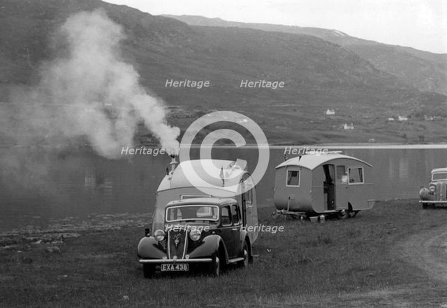 1937 Austin 12hp saloon with caravan. Creator: Unknown.
