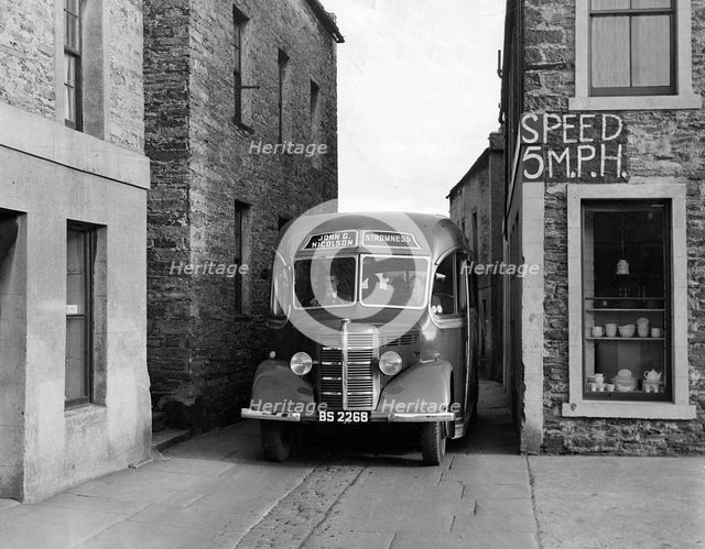 1939-1952 Bedford OB coach in narrow street. Creator: Unknown.