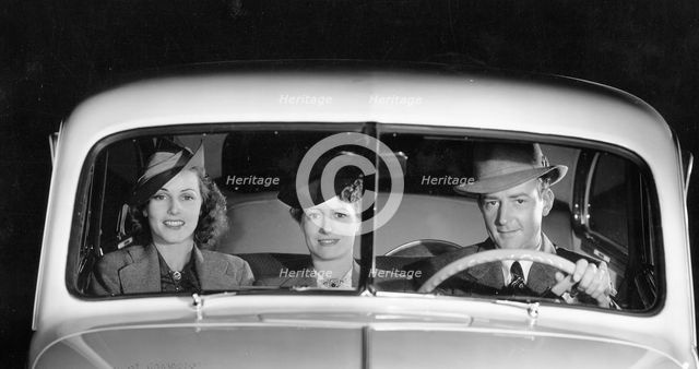 1939 Oldsmobile driver and female passengers. Creator: Unknown.