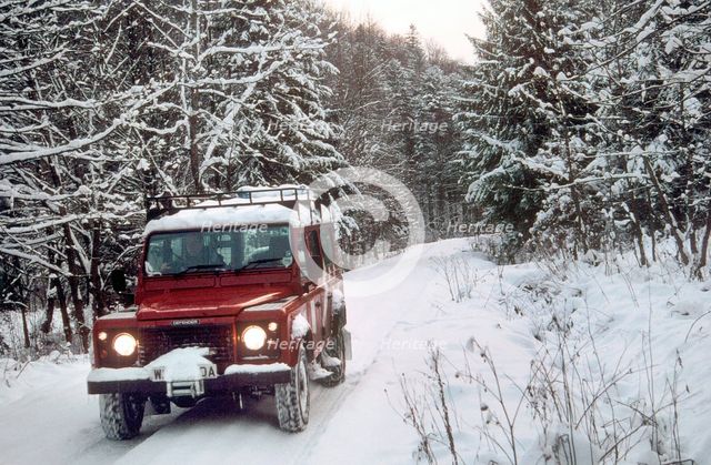 2001 Land Rover Defender driving in snowy conditions. Creator: Unknown.
