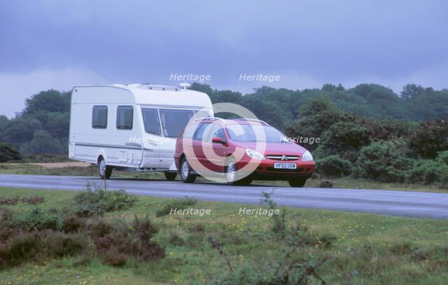 2002 Citroen C5 hdi towing a caravan. Artist: Unknown.