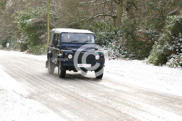 2002 Land Rover Defender driving on snowy road, 2009 Artist: Unknown.