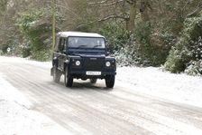 2002 Land Rover Defender driving on snowy road, 2009