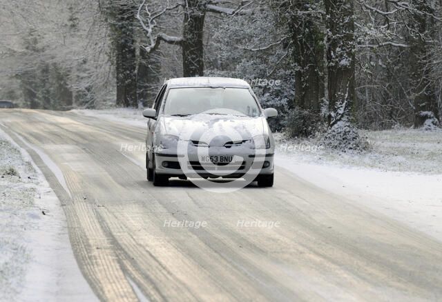 2003 Nissan Almera driving on icy road in winter Artist: Unknown.