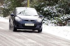 2009 Mazda 2 driving on snowy road