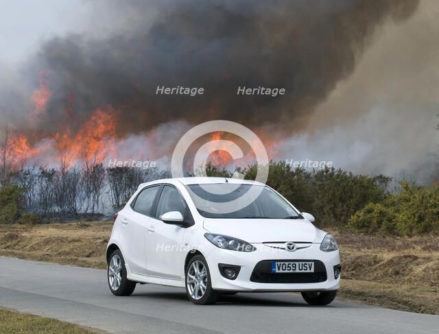2010 Mazda 2 Sport, controlled burning in New Forest Artist: Unknown.