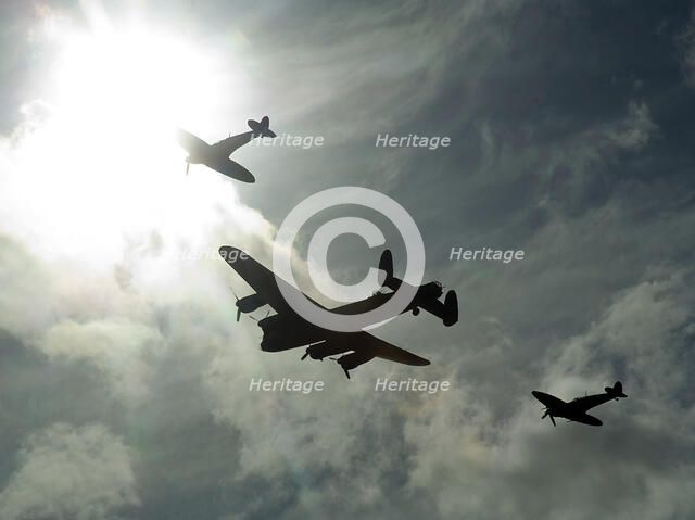 2011 Goodwood Revival Meeting, Lancaster bomber and 2 Spitfires in aerial display. Artist: Unknown.