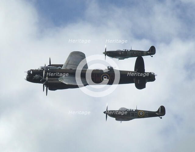 2011 Goodwood Revival Meeting, Lancaster bomber and 2 Spitfires in aerial display. Artist: Unknown.