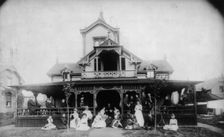 27 men and women (Johnston family) in front of beach house "Dartmouth", c1880. Creator: Unknown