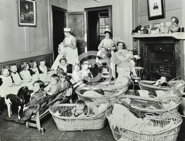 30 Albury Street; Nursey at dinner time, Children in Baskets, 1911. Creator: Unknown.