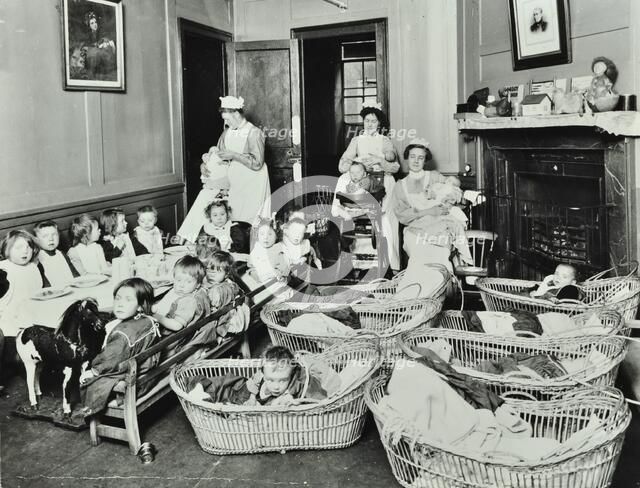 30 Albury Street; Nursey at dinner time, Children in Baskets, 1911. Creator: Unknown.