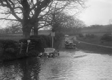 972 cc Singer Le Mans driving through water during a motoring trial, 1936. Artist: Bill Brunell
