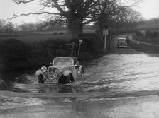 972 cc Singer Le Mans driving through a ford during a motoring trial, 1936. Artist: Bill Brunell