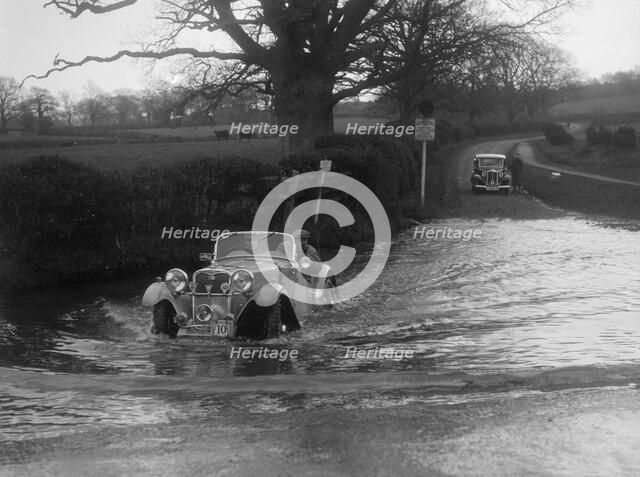 972 cc Singer Le Mans driving through a ford during a motoring trial, 1936. Artist: Bill Brunell.