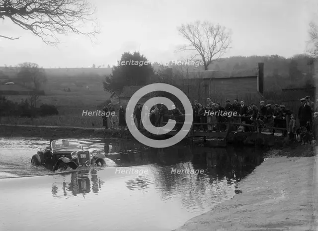 972 cc Singer Le Mans driving through a ford during a motoring trial, 1936. Artist: Bill Brunell.