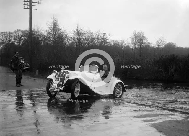 972 cc Singer Le Mans driving through a ford during a motoring trial, 1936. Artist: Bill Brunell.