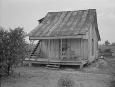 Cotton field hand sitting on her porch on Sunday afternoon, near Blytheville, Arkansas, 1937. Creator: Dorothea Lange