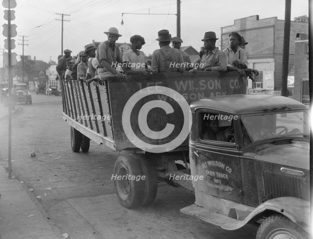 Cotton hoers from Memphis bound for the Wilson Plantation in Arkansas, forty-three miles away, 1937. Creator: Dorothea Lange.