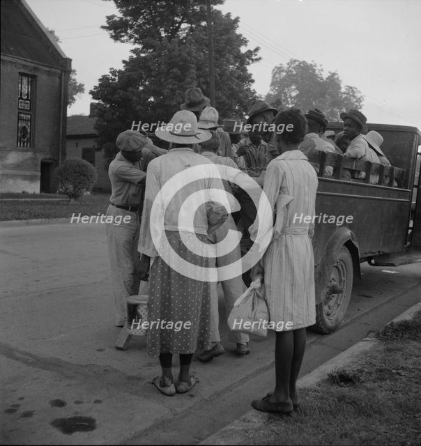 Cotton hoers leaving Greenville at 5 am for a day's work on the plantations, Mississippi, 1937. Creator: Dorothea Lange.