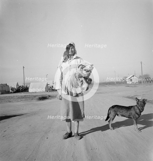 Cotton picker on her way to the cotton field, Kern migrant camp, California, 1936. Creator: Dorothea Lange.