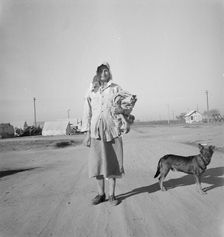 Cotton picker on her way to the cotton field, Kern migrant camp, California, 1936. Creator: Dorothea Lange