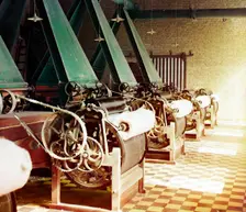 Cotton textile mill interior with machines producing cotton thread, probably..., between 1905-1915. Creator: Sergey Mikhaylovich Prokudin-Gorsky
