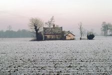Cottage in a snowy field, Eye, Suffolk. Artist: Tony Evans